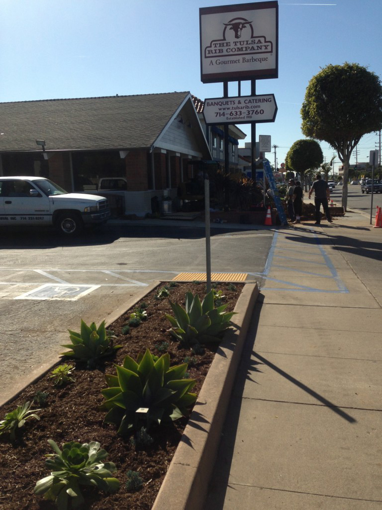 The Tulsa Rib Company storefront with signage, landscaping, and street view