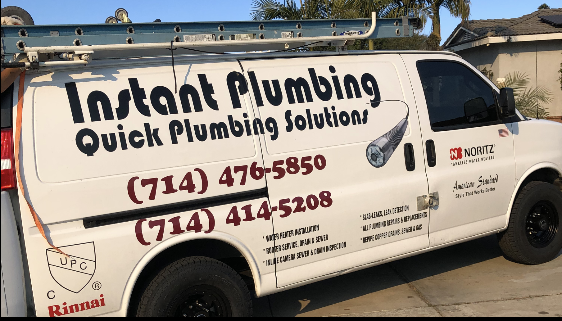 White plumbing service van with "Instant Plumbing" branding and contact numbers displayed on side